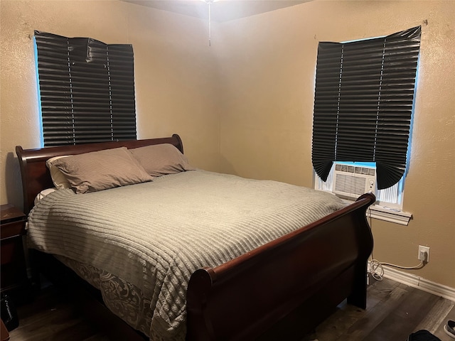 bedroom featuring dark hardwood / wood-style flooring