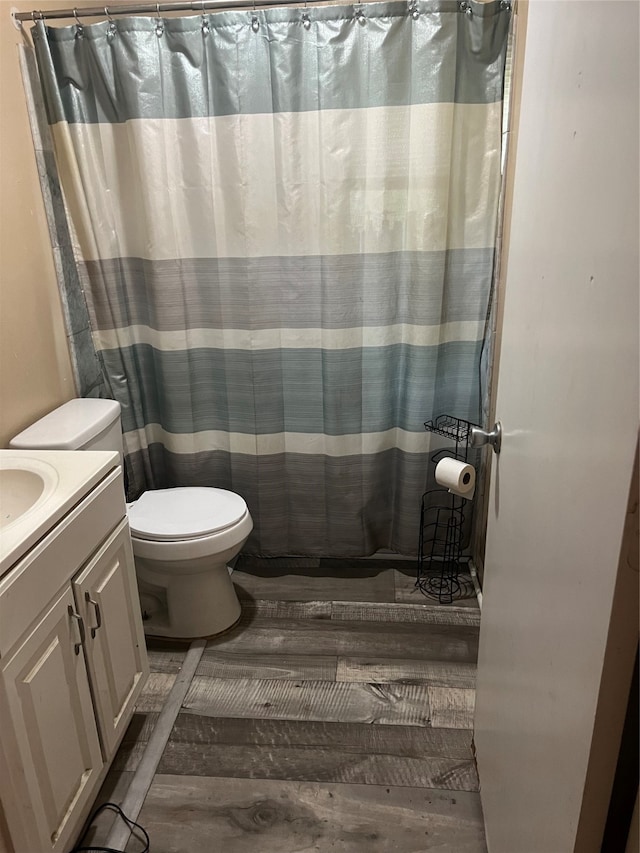 bathroom featuring hardwood / wood-style floors, vanity, and toilet