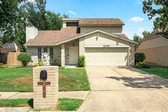 view of front of house with a garage and a front yard