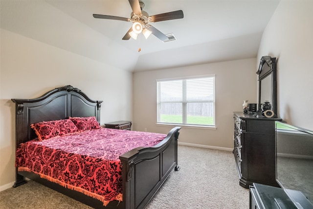 bedroom featuring vaulted ceiling, light carpet, and ceiling fan