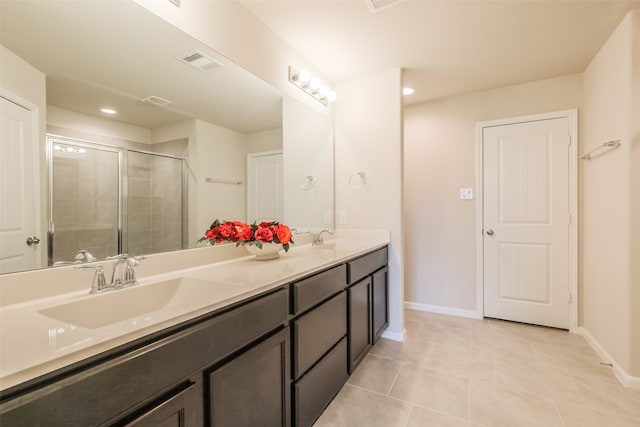 bathroom featuring vanity, tile patterned floors, and walk in shower