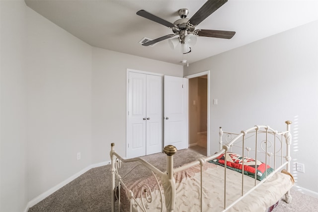 carpeted bedroom with ceiling fan and a closet