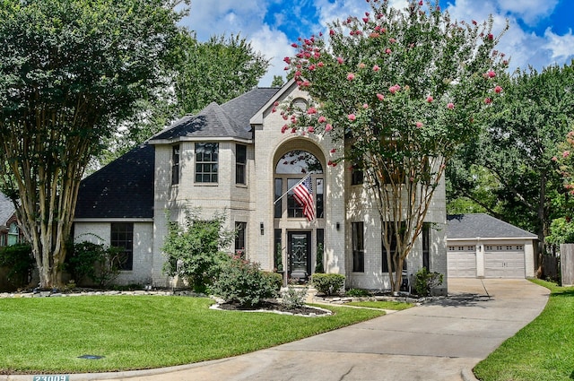 view of front facade with a garage and a front lawn