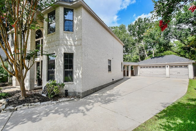 view of home's exterior with an outdoor structure and a garage