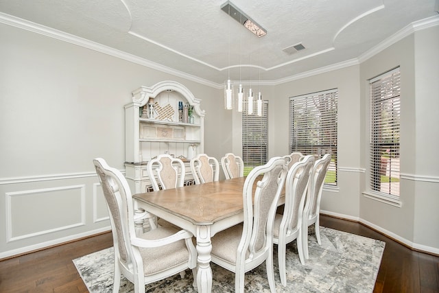 dining room with crown molding, dark hardwood / wood-style flooring, a chandelier, and a textured ceiling