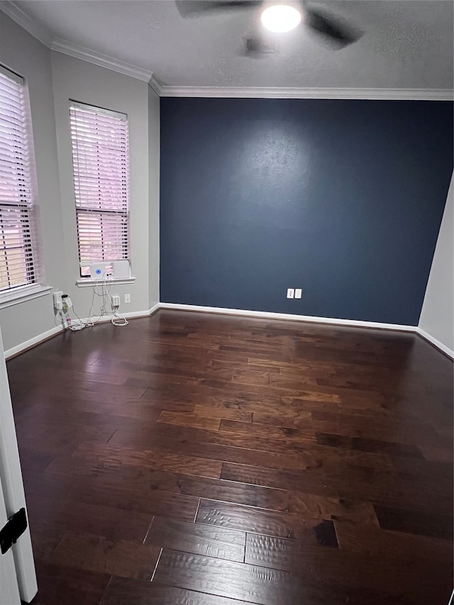 spare room featuring crown molding, dark hardwood / wood-style flooring, and ceiling fan