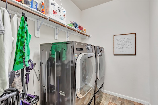 washroom featuring light wood-type flooring and washer and clothes dryer