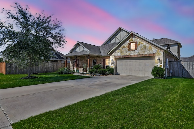 view of front of home with a garage and a lawn