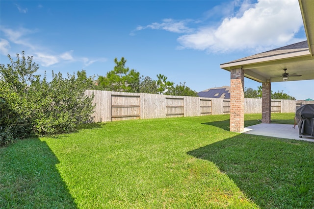 view of yard with ceiling fan and a patio