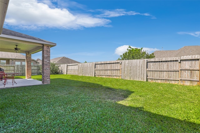 view of yard featuring ceiling fan and a patio