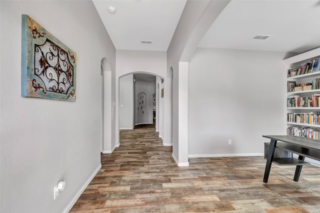 corridor with hardwood / wood-style floors