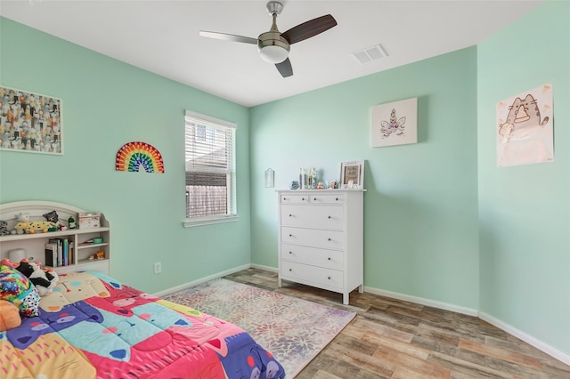 bedroom with light hardwood / wood-style floors and ceiling fan