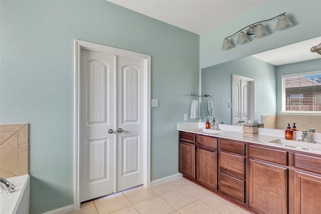 bathroom featuring a tub, vanity, and tile patterned floors