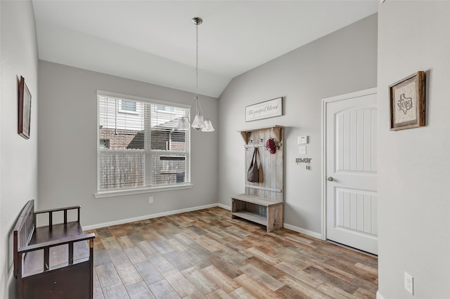 mudroom with a chandelier, vaulted ceiling, and light hardwood / wood-style floors