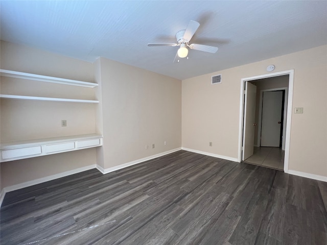 interior space featuring dark wood-type flooring and ceiling fan