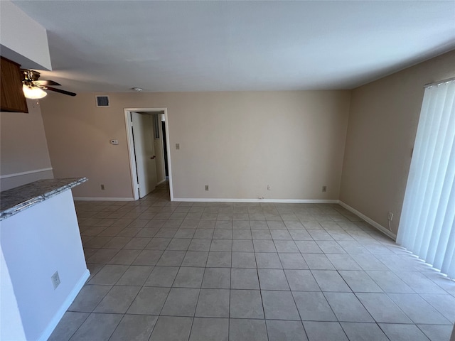 unfurnished living room with ceiling fan and light tile patterned floors