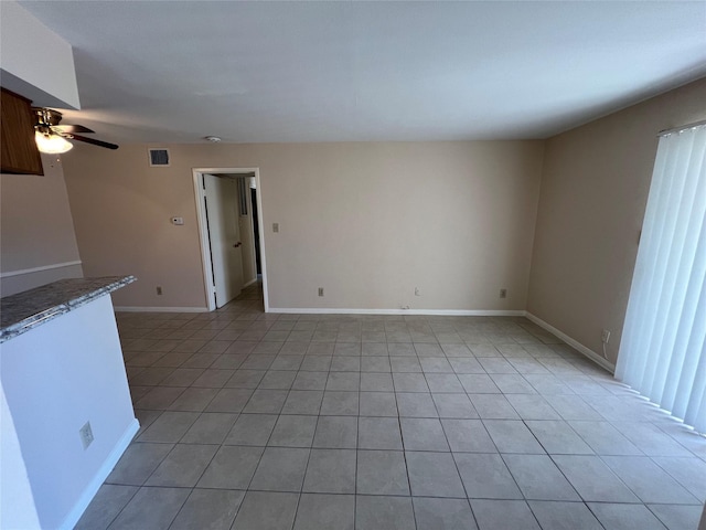 2626 Holly Hall St Unit 1011, Houston, TX 77054 - spare room with light tile patterned flooring, a ceiling fan, and baseboards