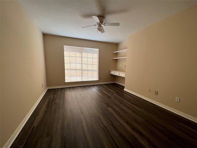 2626 Holly Hall St Unit 1011, Houston, TX 77054 - unfurnished living room featuring a ceiling fan, dark wood finished floors, and baseboards