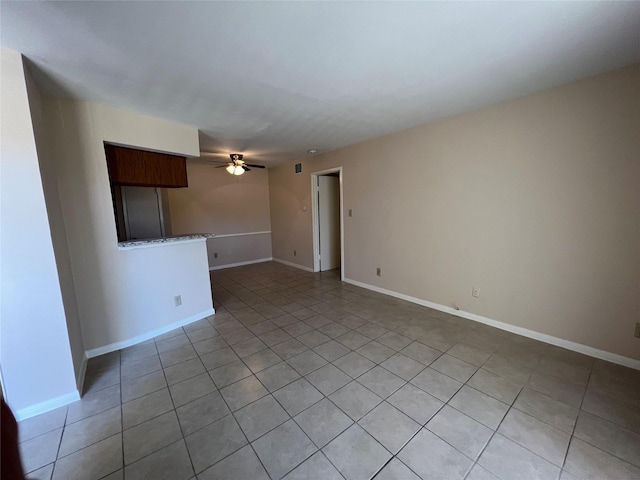 2626 Holly Hall St Unit 1011, Houston, TX 77054 - empty room with a ceiling fan, light tile patterned flooring, and baseboards