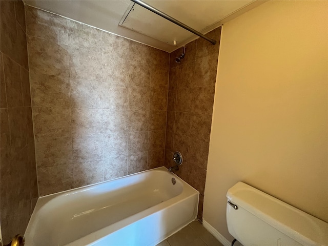 bathroom with tiled shower / bath, tile patterned floors, and toilet