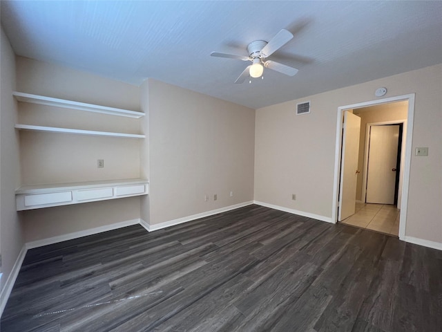 2626 Holly Hall St Unit 1011, Houston, TX 77054 - unfurnished living room with wood finished floors, ceiling fan, and baseboards
