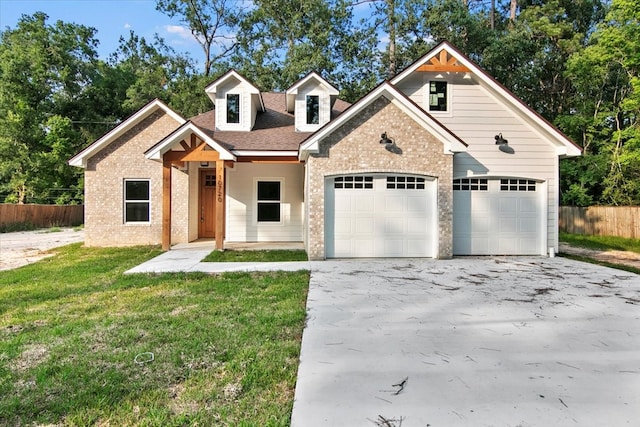 view of front of property featuring a porch, a front lawn, and a garage