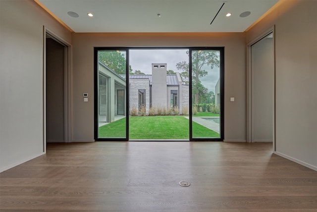 doorway with light wood-type flooring