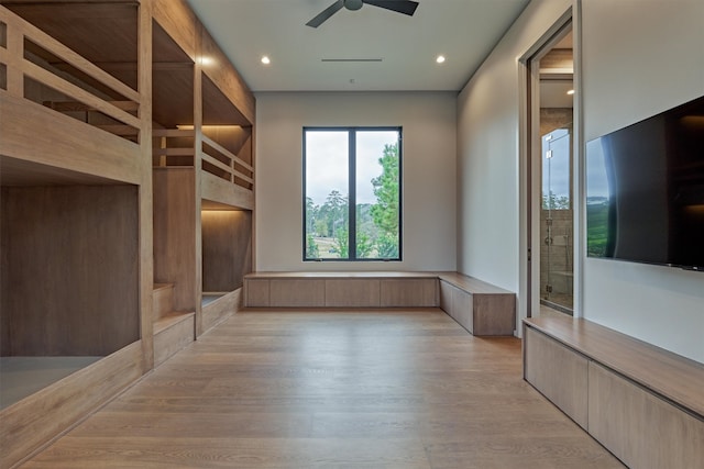 unfurnished bedroom featuring light wood-type flooring and ceiling fan