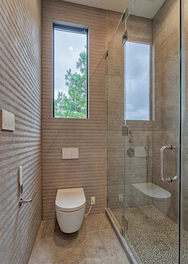 bathroom featuring toilet, tile patterned floors, and walk in shower