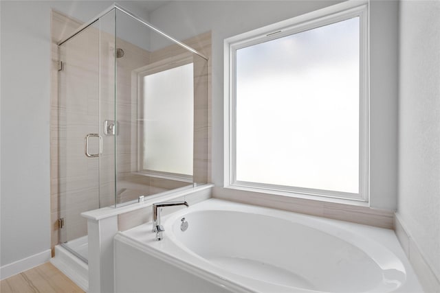bathroom with a garden tub and a stall shower