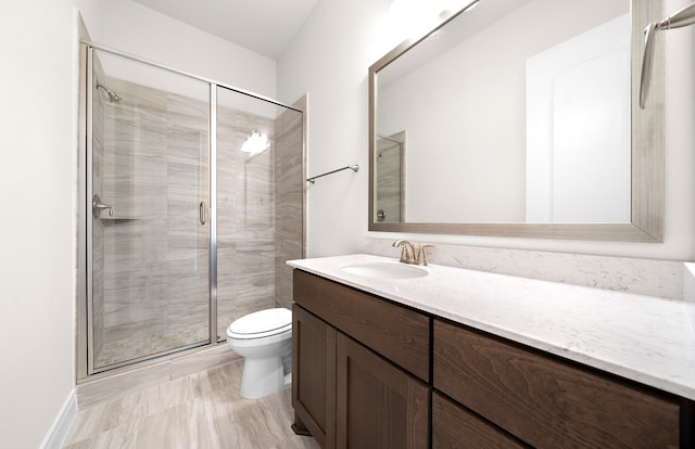 bathroom featuring walk in shower, vanity, and toilet