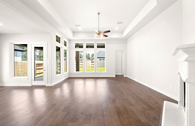 unfurnished living room featuring dark hardwood / wood-style flooring and ceiling fan