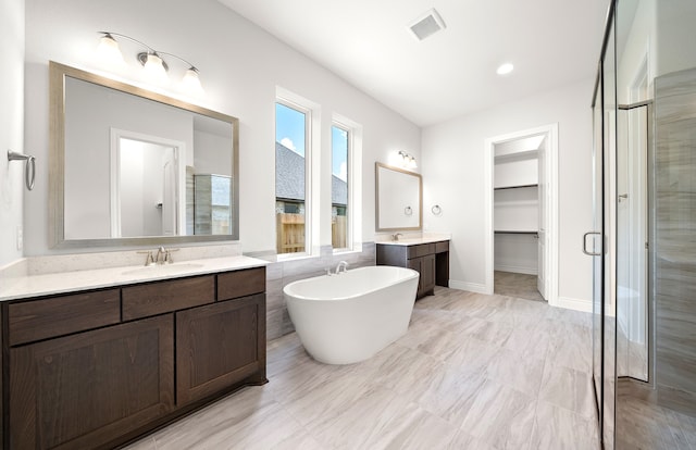 bathroom featuring independent shower and bath and vanity