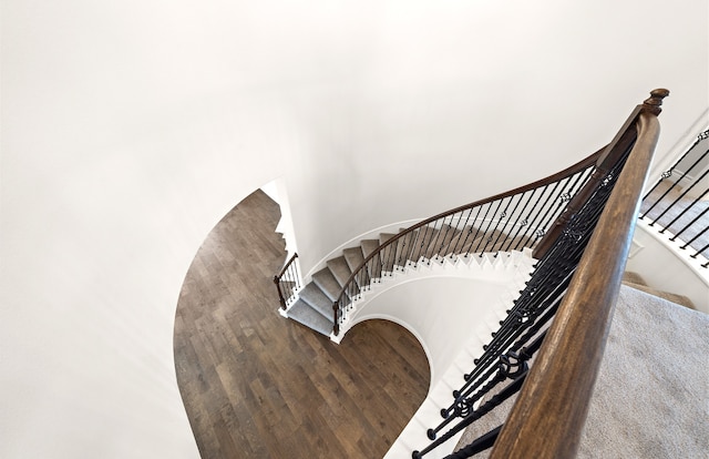 stairs featuring wood-type flooring