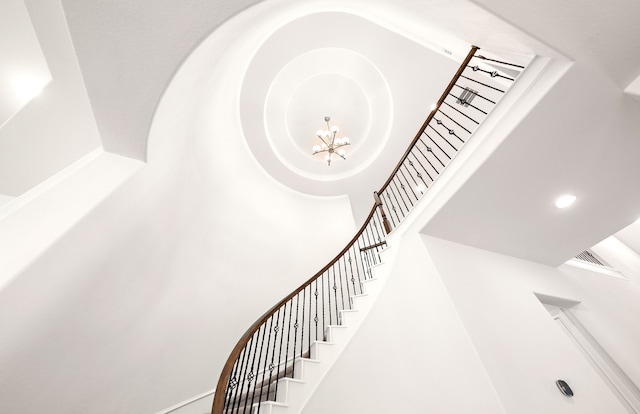 staircase featuring a chandelier