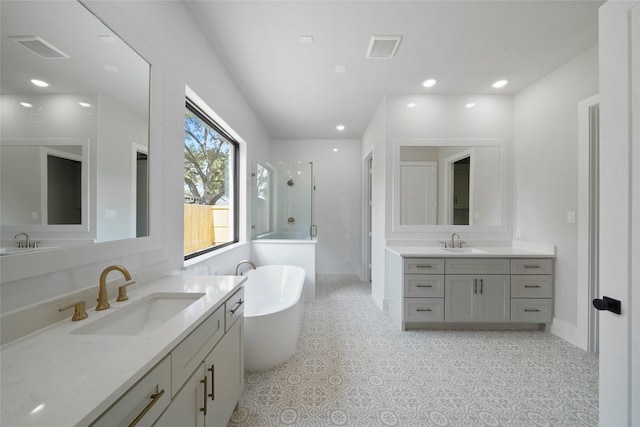 full bathroom featuring two vanities, a sink, and visible vents