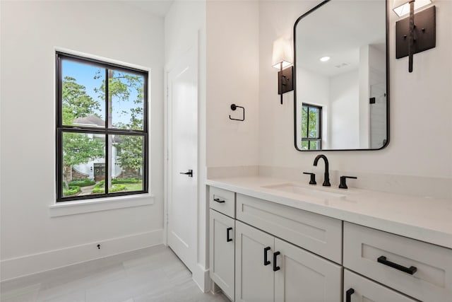 bathroom featuring baseboards and vanity
