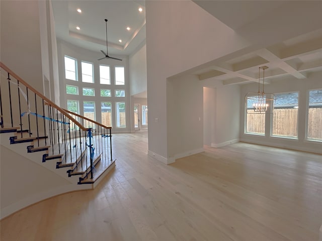 interior space featuring recessed lighting, beamed ceiling, baseboards, light wood-style flooring, and stairs