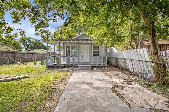 view of front of home with covered porch and a front yard