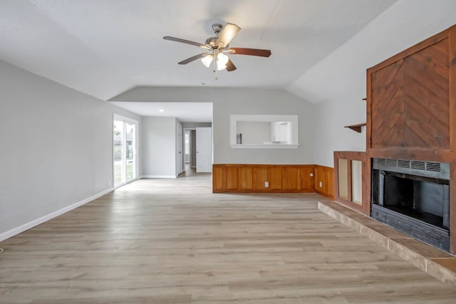 unfurnished living room with light wood-type flooring, vaulted ceiling, and ceiling fan