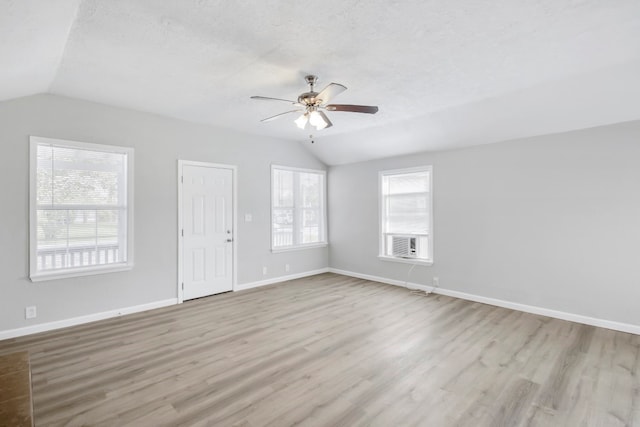 unfurnished living room featuring a textured ceiling, light hardwood / wood-style flooring, lofted ceiling, and ceiling fan