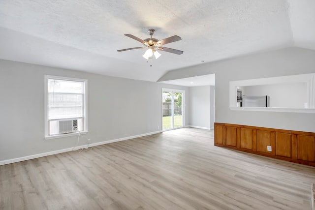 unfurnished living room featuring a textured ceiling, vaulted ceiling, ceiling fan, and light hardwood / wood-style flooring