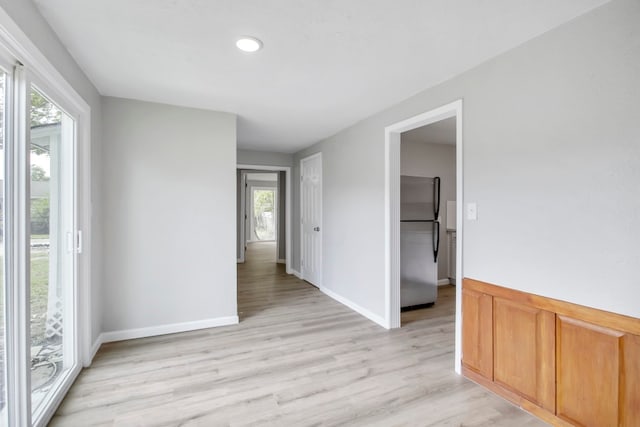 empty room with light hardwood / wood-style floors