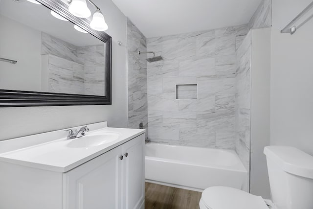 full bathroom featuring toilet, tiled shower / bath combo, vanity, and hardwood / wood-style floors