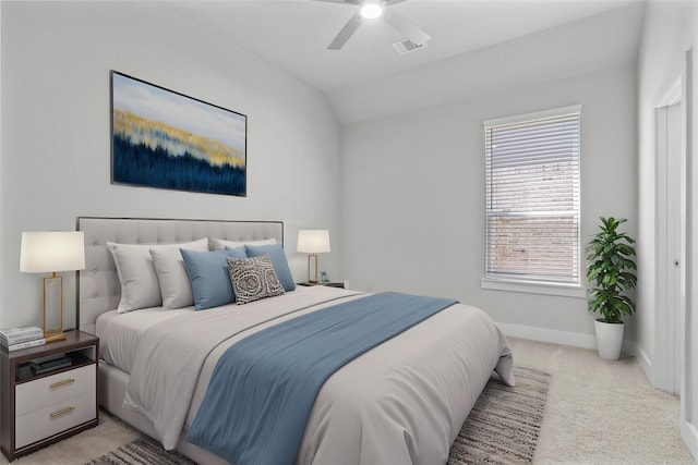 carpeted bedroom with ceiling fan and vaulted ceiling