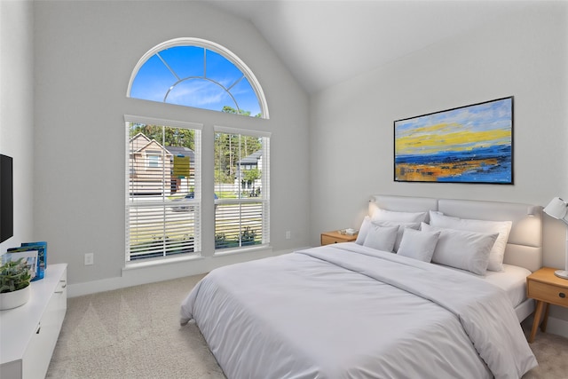 bedroom featuring light carpet and vaulted ceiling