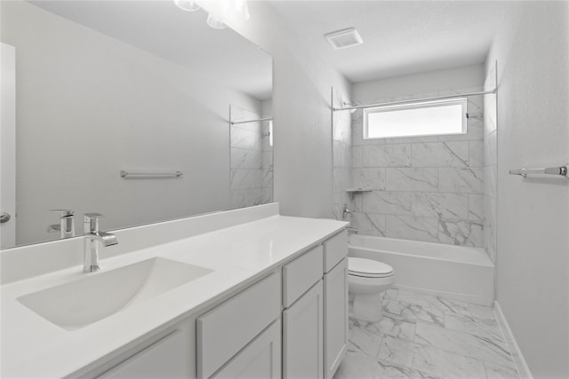 full bathroom featuring toilet, tiled shower / bath combo, and vanity