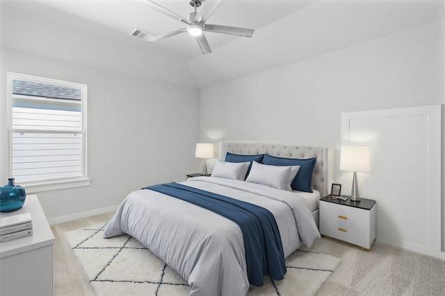 bedroom with ceiling fan, lofted ceiling, and light colored carpet