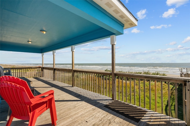 deck with a water view and a beach view