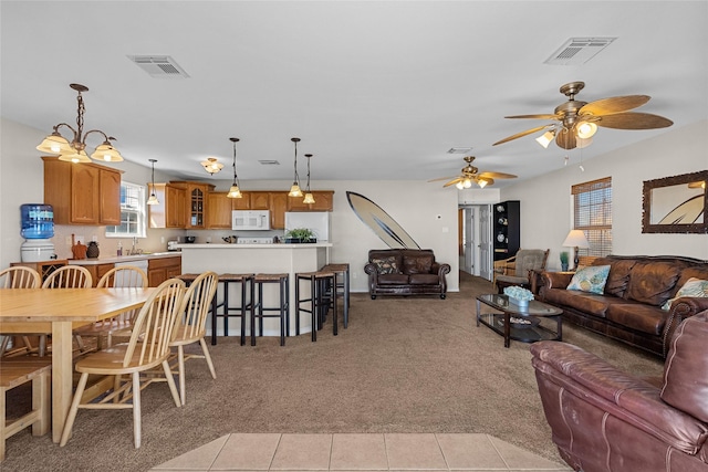 211 Ocean Dr, Surfside Beach, TX 77541 - living room with ceiling fan, light carpet, and light tile patterned floors